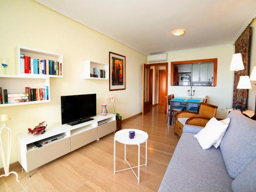 a living room with a couch and a tv at Apartment Sotavento by Interhome in Calpe