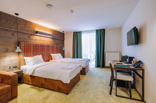 Ένα ή περισσότερα κρεβάτια σε δωμάτιο στο Iglika Hotel Borovets