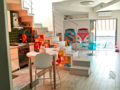 a kitchen with a staircase and a table and chairs at Relais sul Tempio in Pozzuoli