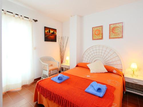 a bedroom with a bed with two towels on it at Holiday Home Puig Dels Daus by Interhome in Calonge