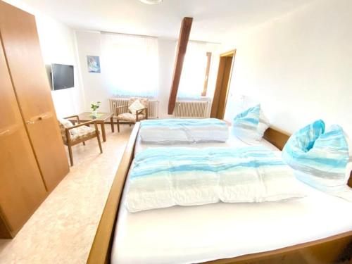 a bedroom with a large bed in a room at Gasthaus Dernedde in Osterode