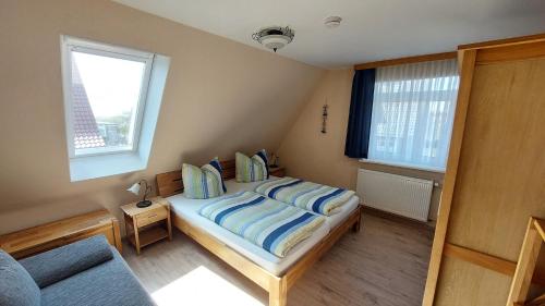 מיטה או מיטות בחדר ב-Ferienhaus Nordstrand Whg 4