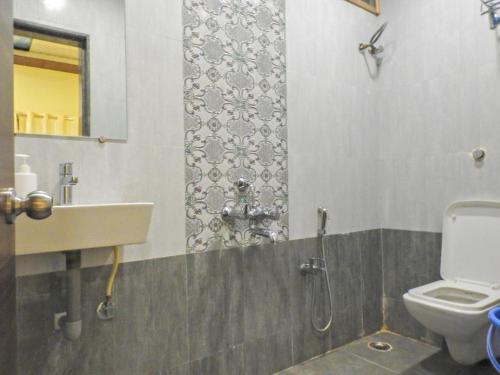 a bathroom with a sink and a toilet at Evergreen Holidays Mahabaleshwar in Mahabaleshwar