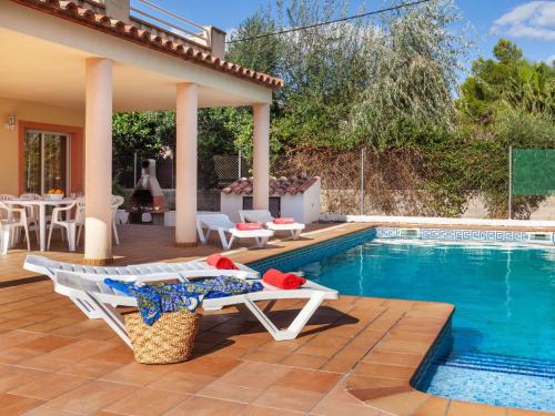 a villa with a swimming pool and a patio at Villa Villa Cala Nova B by Interhome in Les tres Cales
