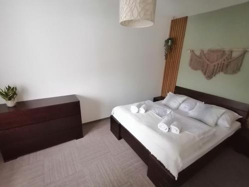 a bedroom with a bed with white sheets and pillows at Karczma Karnasów in Cisna