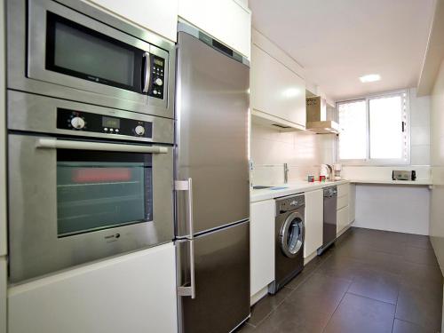 a kitchen with a refrigerator and a washer and dryer at Apartment Gabriel by Interhome in Calpe