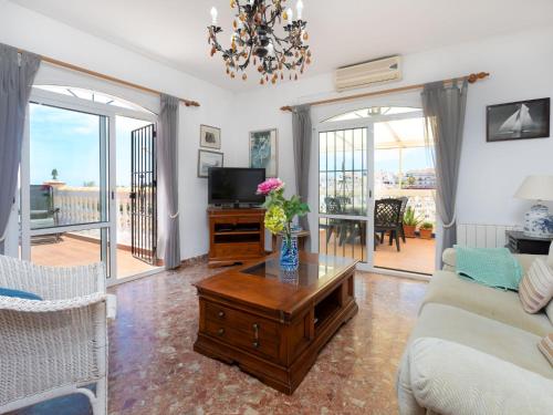 a living room with a couch and a table at Holiday Home Nerja Penthouse by Interhome in Nerja