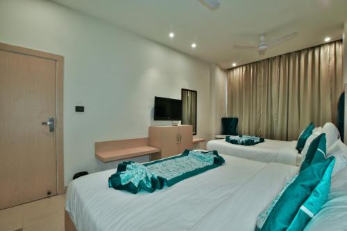 Ένα ή περισσότερα κρεβάτια σε δωμάτιο στο Hotel Puri Palace