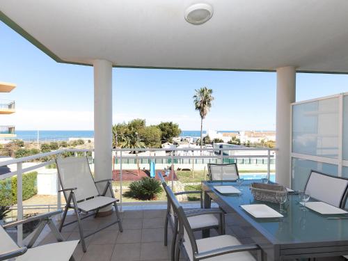 a patio with a table and chairs and a view of the ocean at Apartment Marina Park-1 by Interhome in Denia
