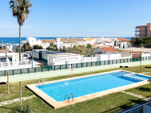a swimming pool with the ocean in the background at Apartment Marina Park-1 by Interhome in Denia