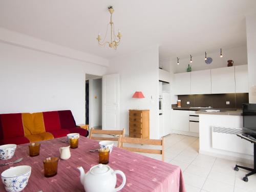 a kitchen and a living room with a table with drinks on it at Apartment Riva Bella-3 by Interhome in Cavalaire-sur-Mer