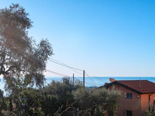 a house on a hill with the ocean in the background at Apartment Casa dei miei by Interhome in Civezza