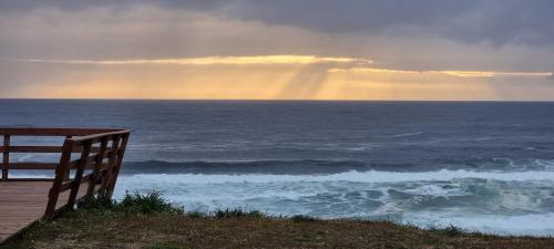 a view of the ocean with a rainbow in the sky at Domos Curiñanco vista al mar in Valdivia