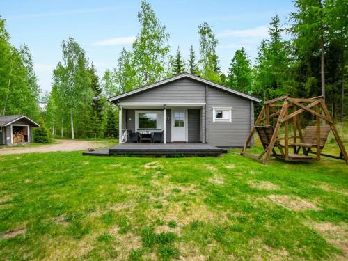 a tiny house in the woods with a large yard at Holiday Home Lehtikuusenranta by Interhome in Hankamäki