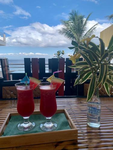 two cocktails are sitting on a tray on a table at The Philip Ann Resort in Mabini
