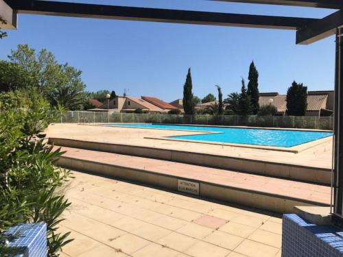 a large swimming pool in a yard with at Holiday Home Les Aloès by Interhome in Sainte-Marie-la-Mer
