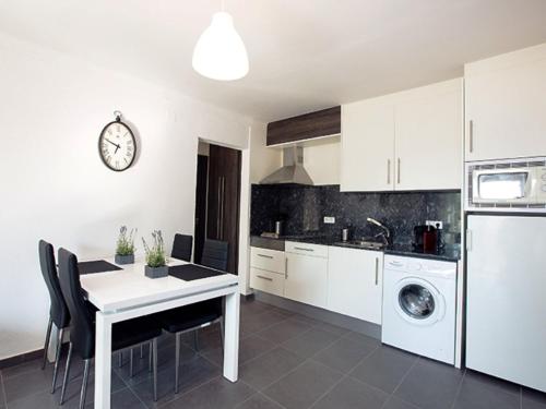 a kitchen with a table and a dining room at Apartment Port Banyuls-1 by Interhome in Empuriabrava