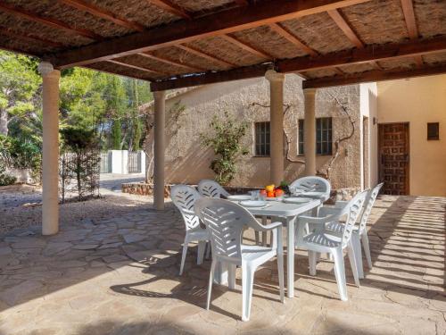 a white table and chairs on a patio at Villa Villa Illot by Interhome in Les tres Cales