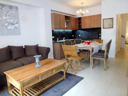 a living room with a couch and a table at Holiday Home Villa Morny-1 by Interhome in Deauville