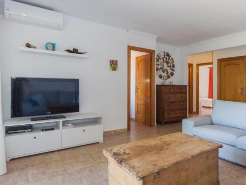 a living room with a tv and a couch at Apartment Sorts de la Mar-1 by Interhome in Denia