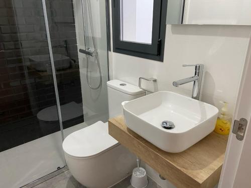 a bathroom with a sink and a toilet and a shower at CASA ENEKO in Seville