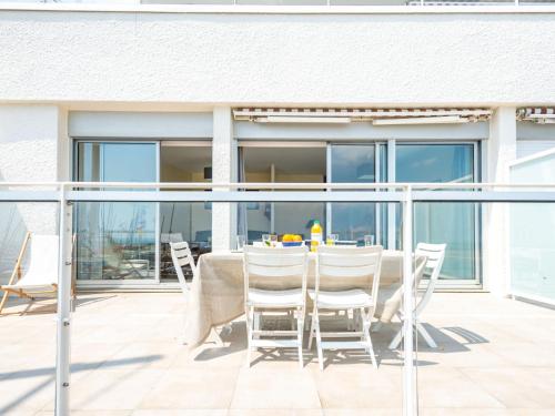 a table and chairs on the balcony of a house at Apartment Atlantique-2 by Interhome in Carnac