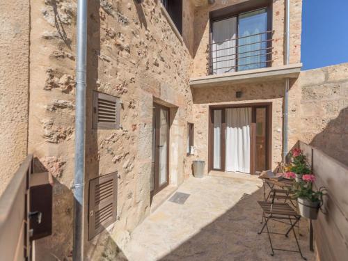 an external view of a building with chairs and a balcony at Holiday Home Es Reco by Interhome in Costitx