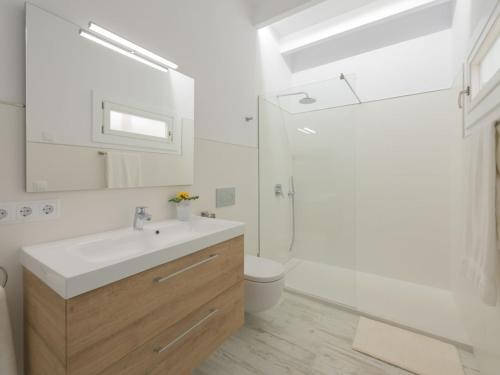 a bathroom with a sink and a toilet and a mirror at Holiday Home Es Reco by Interhome in Costitx