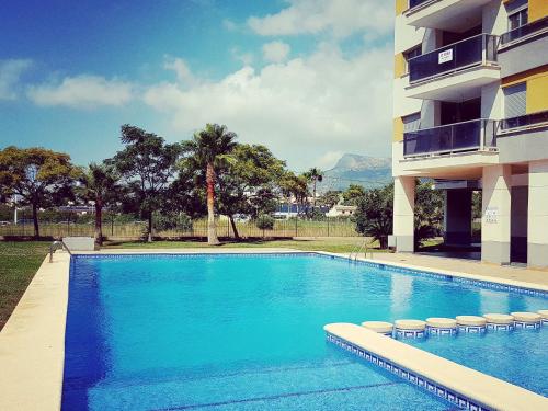 a swimming pool in front of a building at Apartment Costa Calpe by Interhome in Calpe