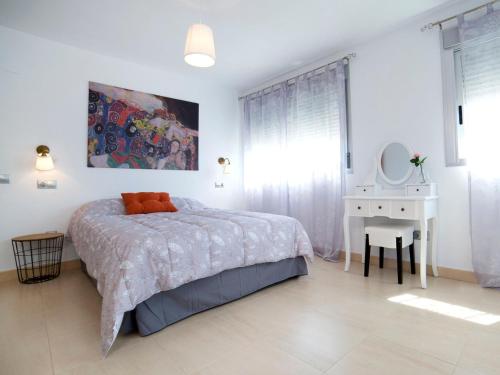 a bedroom with a bed and a desk and a mirror at Apartment Costa Calpe by Interhome in Calpe