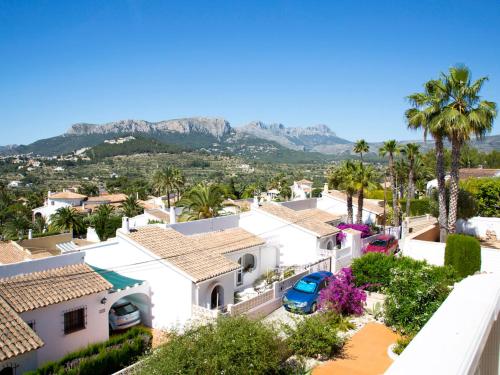 arial view of a house with palm trees and mountains at Holiday Home Yona by Interhome in Empedrola