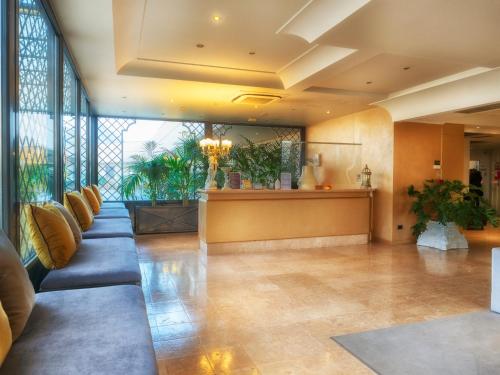 a lobby of a hotel with a waiting room at Hotel Europa in Palazzolo sullʼOglio