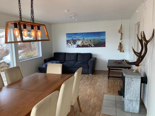 a living room with a table and a blue couch at Apartments Reine Lofoten in Reine