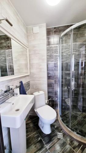 a bathroom with a toilet and a sink and a shower at The View Veliko Tarnovo in Veliko Tŭrnovo