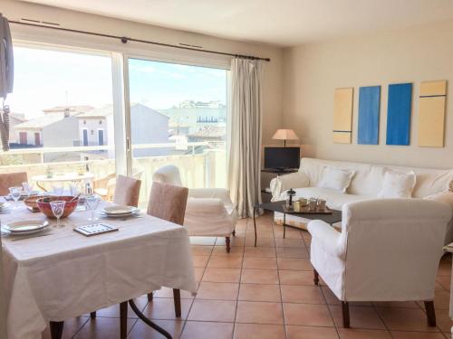 a living room with a couch and a table and chairs at Apartment Le Panoramic by Interhome in Sainte-Maxime
