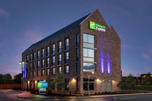a brick building with the word kings on it at Holiday Inn Express Cambridge West - Cambourne by IHG in Cambridge