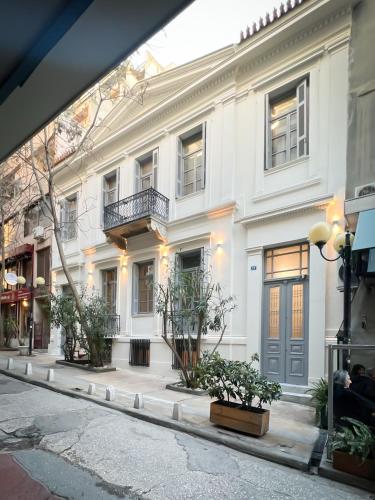 un grand bâtiment blanc dans une rue de la ville dans l'établissement When in Athens Hostel, à Athènes