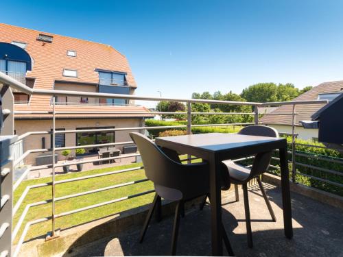 a table and chairs on the balcony of a building at Apartment Tivoli Gardens-4 by Interhome in Mispelburg