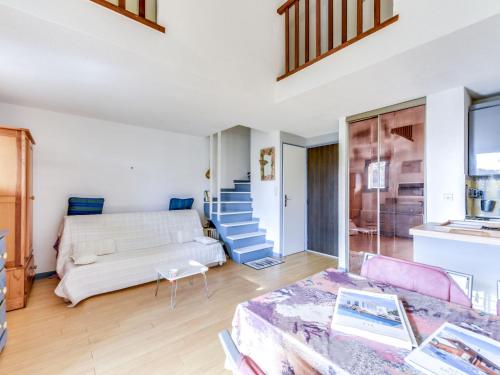 a living room with a couch and a table at Studio Val des Chênes-6 by Interhome in Cavalaire-sur-Mer