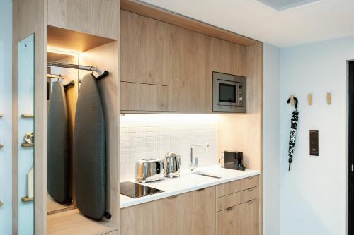 a small kitchen with a sink and a sink at Wilde Aparthotels Manchester City Centre in Manchester