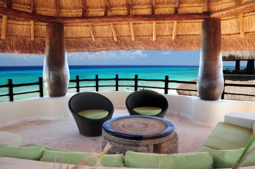 a living room with a view of the ocean at El Taj Oceanfront and Beachside Condo Hotel in Playa del Carmen