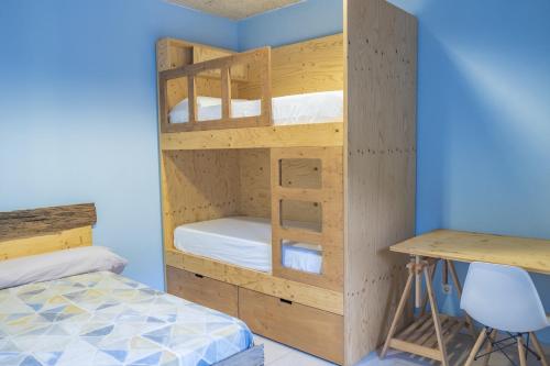a bunk bed with a desk in a room at La Rectoria d'Albanyà in Albanya