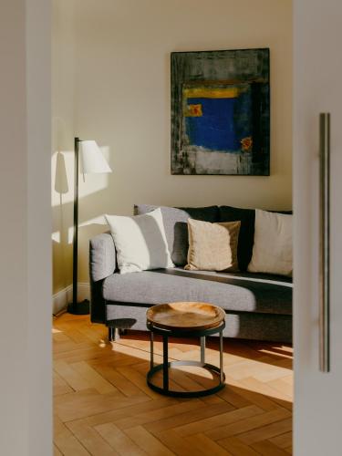a living room with a couch and a table at Bad Hotel Überlingen in Überlingen