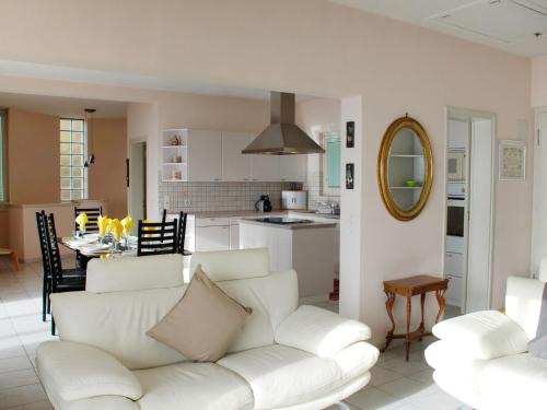 a living room with a white couch and a kitchen at Holiday Home Daniele by Interhome in Cademario