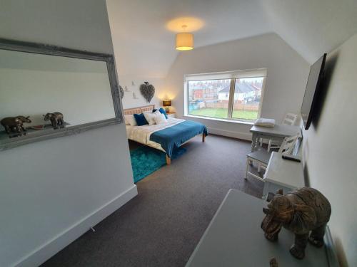 a bedroom with a bed and a large window at Riverdale House(4 Bedrooms) Serviced Accommodation in Grimsby