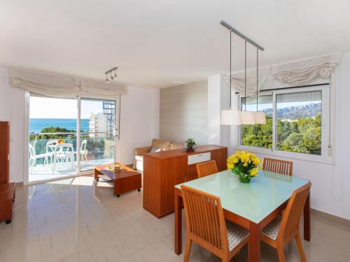 a living room with a table and chairs with a view at Apartment Gala I-3 by Interhome in Miami Platja