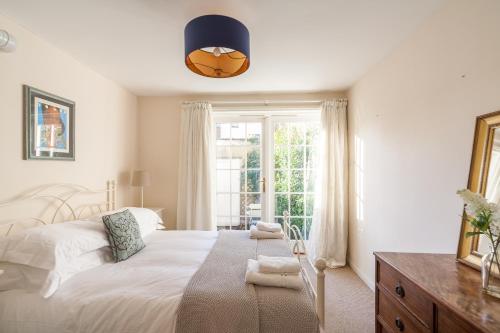 a bedroom with a white bed and a window at Camden Crescent in Bath