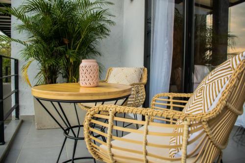 a table and chairs on a porch with a vase on it at Santuario Luxury Eco Hotel in Villeta