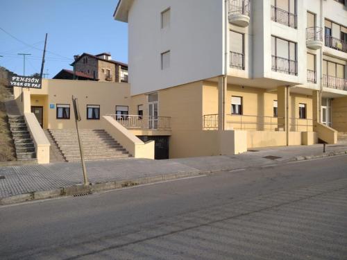 an empty street in front of a building at Pensión Vega de Pas in Comillas