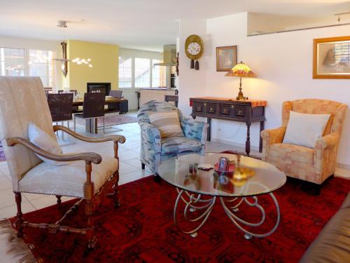 a living room with a coffee table and chairs at Apartment Carina by Interhome in Wilderswil